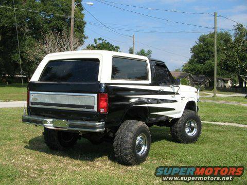 Black and white lifted Ford Bronco, 3q-front view