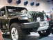 1986 Ford Bronco - A green Jeep Gladiator Concept vehicle is displayed indoors with a prominent chrome grille and off-road tires.