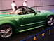 1986 Ford Bronco - Side view of a green convertible sports car, likely a Ford Mustang, on display.