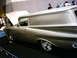 1986 Ford Bronco - Custom panel van with chrome wheels and hood open, displayed indoors.