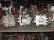 1969 Ford Bronco - A collection of carburetors displayed on a workbench, surrounded by various automotive tools and supplies.