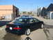 1995 Ford Taurus - This 1995 Ford Taurus is seen from the rear 3/4 angle in a lot with another car present.