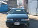 1995 Ford Taurus - This 1995 Ford Taurus is seen from the front, parked in an industrial area.