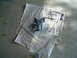 1979 Ford Bronco - A metal bracket, likely a car part, is placed on newspapers for painting.