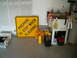 1979 Ford Bronco - A garage scene a traffic sign, various containers, and a utility sink with cleaning supplies.