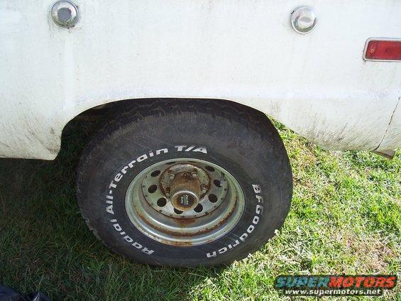 White vehicle fender and BFGoodrich All-Terrain T/A tire on a steel wheel