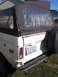 1974 Ford Bronco - This 1974 Ford Bronco features a black soft top and a spare tire mounted on the rear tailgate.