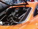 1986 Ford Bronco - Close-up of the engine bay in an orange sports car, showing the intake system.