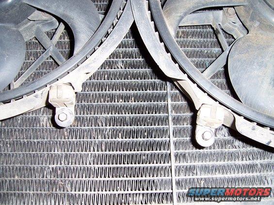 Close-up of a vehicle radiator with two electric fans mounted