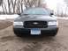 1999 Ford Crown Victoria - Dark Ford Crown Victoria parked outside in winter with snow on the ground.