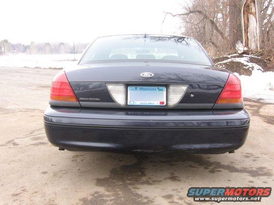Dark blue Ford Crown Victoria rear view. Minnesota license plate visible. Some scuffing on bumper
