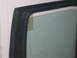 1991 Ford Bronco - Close-up of a vehicle's interior door frame and window, showing a textured black finish and a yellow sticker on the glass.