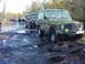 1995 Dodge 1500 - Several off-road vehicles navigate a wet, muddy path through a wooded area.