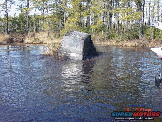 1995 Dodge 1500 stuck in mud and water, rear view, partially submerged