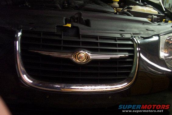 1999 Chrysler 300M front grille with chrome trim and emblem, hood open