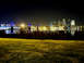1994 Ford Probe - The lights of a city reflect on the water at night, with a bridge in the background.