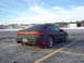1994 Ford Probe - Rear view of a black Ford Probe, parked in a lot with snow on the ground.
