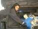 1978 Ford Bronco - A young girl works on a blue engine, which is partially covered by a black tarp.