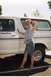 1976 Ford F-150 - A woman poses next to a white Ford Bronco, identified by the "Ford Filly" text on the door.