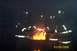 1998 Ford Crown Victoria - Firefighters are seen in protective gear around a burning fire pit, with the date 01/05/2006 visible.