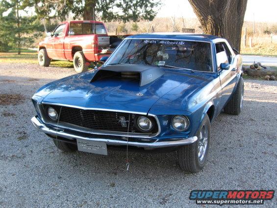 Blue 1969 Ford Mustang with hood scoop and 'Old School' decal