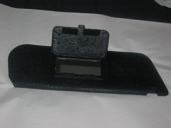 Black dashboard part with flip-up cover and mirrored compartment