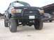 1990 Ford Bronco - This modified 1990 Ford Bronco has a lifted suspension and off-road tires, with a damaged windshield.