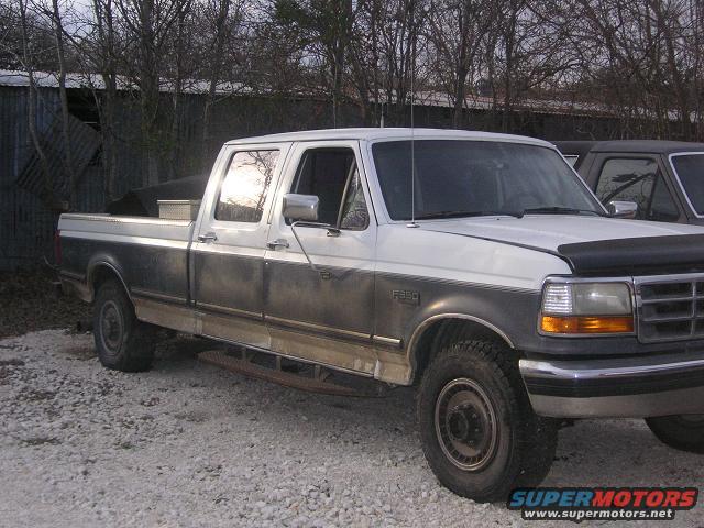 1992 Ford F-350 pickup truck, white and gray, parked outside