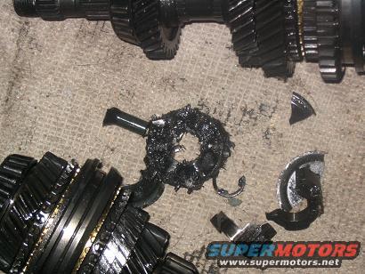 Damaged transmission gears with metal shavings and broken pieces