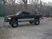 2001 Dodge 1500 - Lifted 2001 Dodge 1500 pickup truck with custom front bumper and large tires.