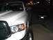 2001 Dodge 1500 - A white pickup truck is parked at night, with another vehicle in the background.