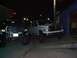 2001 Dodge 1500 - Two Dodge Ram pickup trucks are parked outside a building at night.