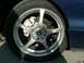 1995 Ford Probe - Close-up of a car's wheel and brake assembly, showing an aftermarket wheel and white caliper.