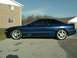 1995 Ford Probe - Side profile of a blue 1995 Ford Probe GT with aftermarket wheels.