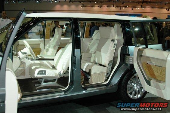 Concept SUV interior with light-colored seats and wood trim, doors open