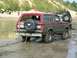 1995 Ford Bronco - This 1995 Ford Bronco is navigating a muddy off-road course, with a spare tire mounted on the rear.