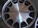 1999 Ford Taurus - A close-up view of a silver alloy wheel with the Ford emblem in the center.