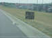 1978 Ford F-250 - A sign offers a free cat next to a deceased feline on the side of the road.