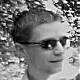 Close-up of a person in sunglasses against a blurred background