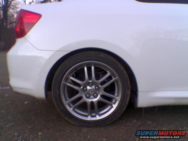 White 2005 Scion tC rear wheel and quarter panel