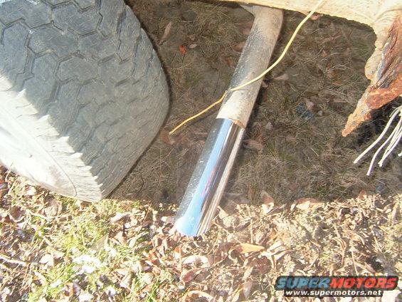 Exhaust pipe tip and tire tread on the ground