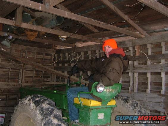 Green tractor interior with man in driver's seat