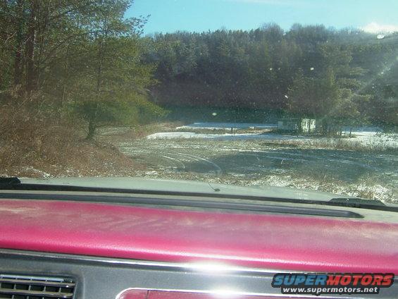 Interior view of a pink dashboard looking out at a snowy landscape