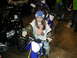 1979 Ford Bronco - Child poses on a dirt bike at an indoor event with other vehicles around.