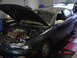 1994 Mazda 626 - Dark green sedan with hood open, revealing the engine bay and some aftermarket modifications.