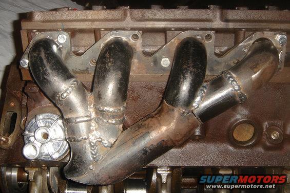 Custom exhaust manifold welded onto an engine block