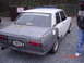 1994 Mazda 626 - Rear view of a Datsun 510 sedan, showing primer gray bodywork on the rear quarter panels.