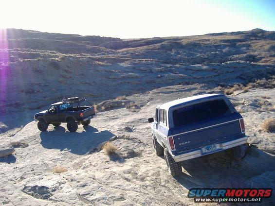 Blue 1978 Ford Bronco rear view on rocky terrain