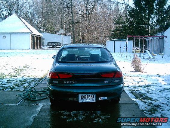 Rear view of a 1997 Ford Escort LX parked in a snowy driveway