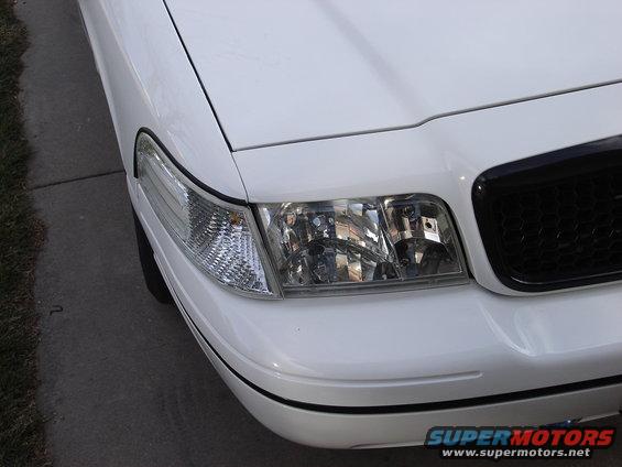 White 2000 Ford Crown Victoria front corner with black grille